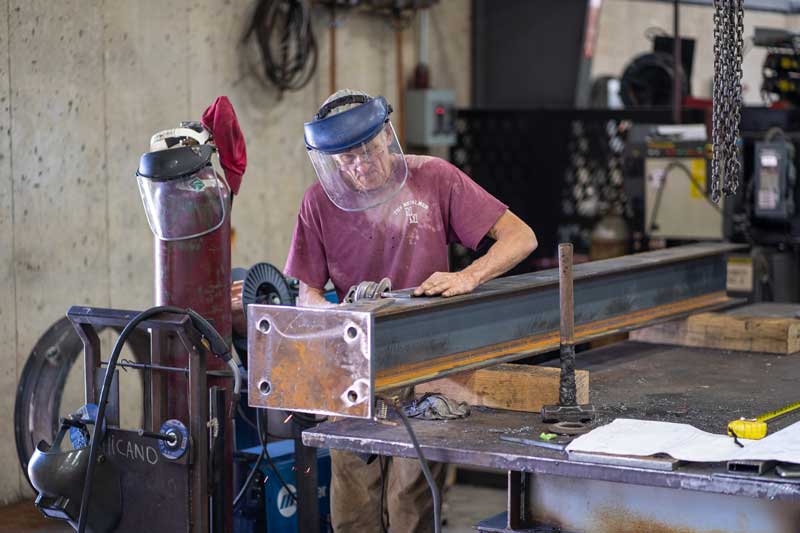 H&H employee working on metal beam