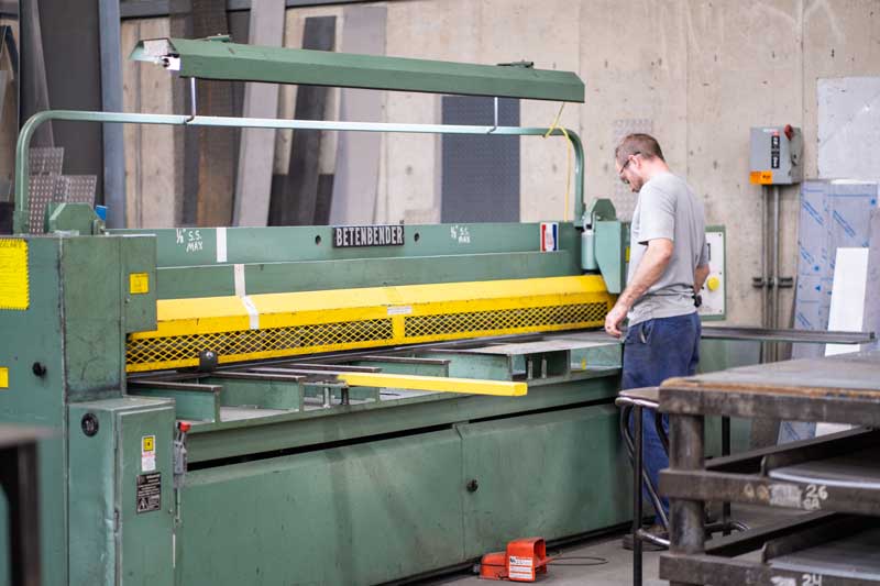 H&H employee operating metal fabrication machine