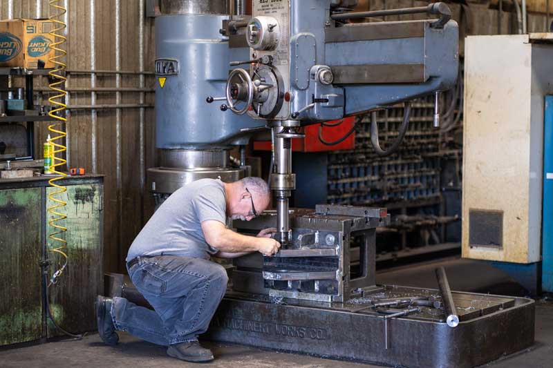 H&H employee working to repair metal machine