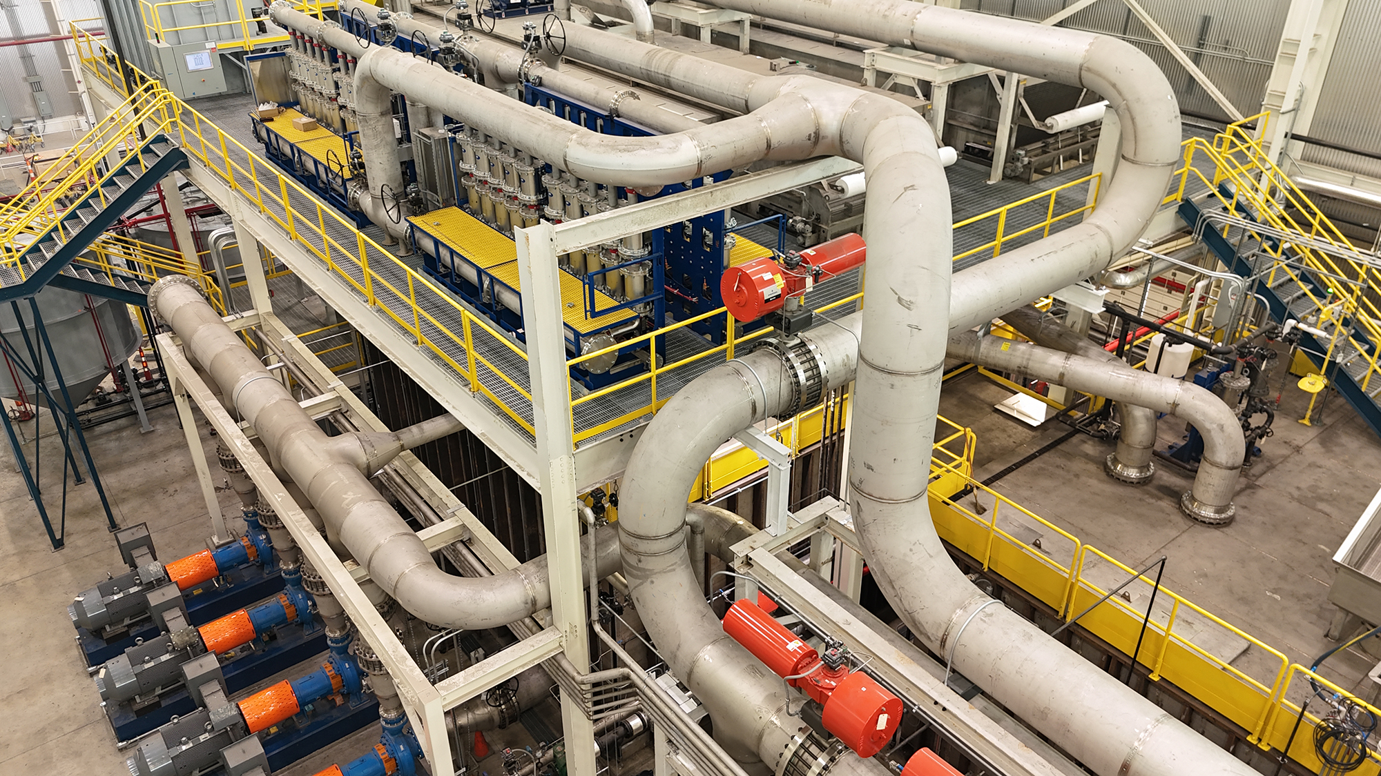 Industrial process piping installation featuring stainless steel manifolds and pumps by H&H Sheet Metal in Russellville, KY.